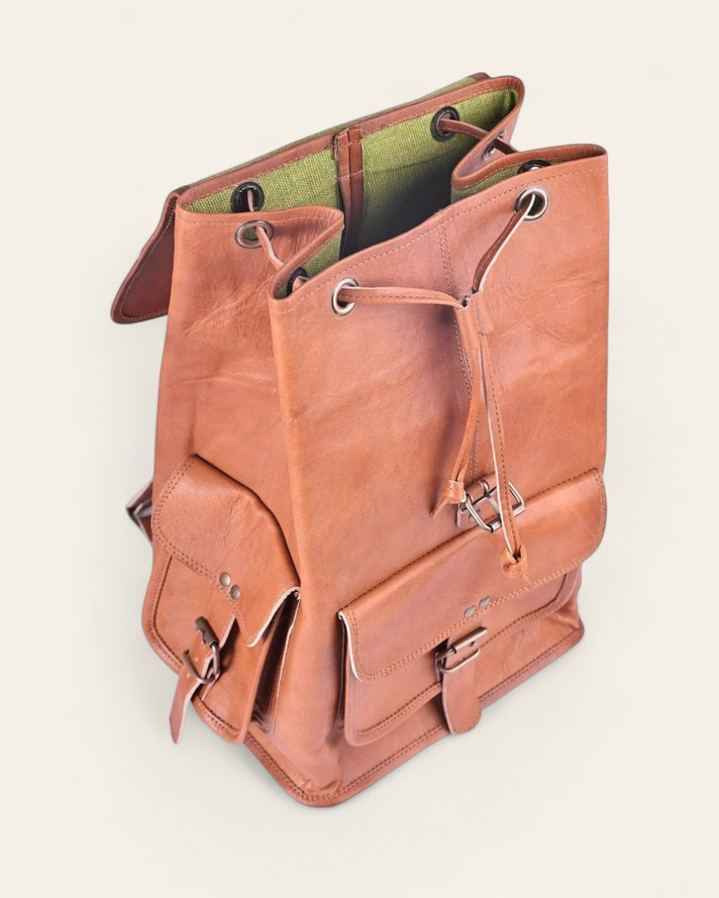 The Aravalli Backpack — open drawstring top showing the green canvas interior