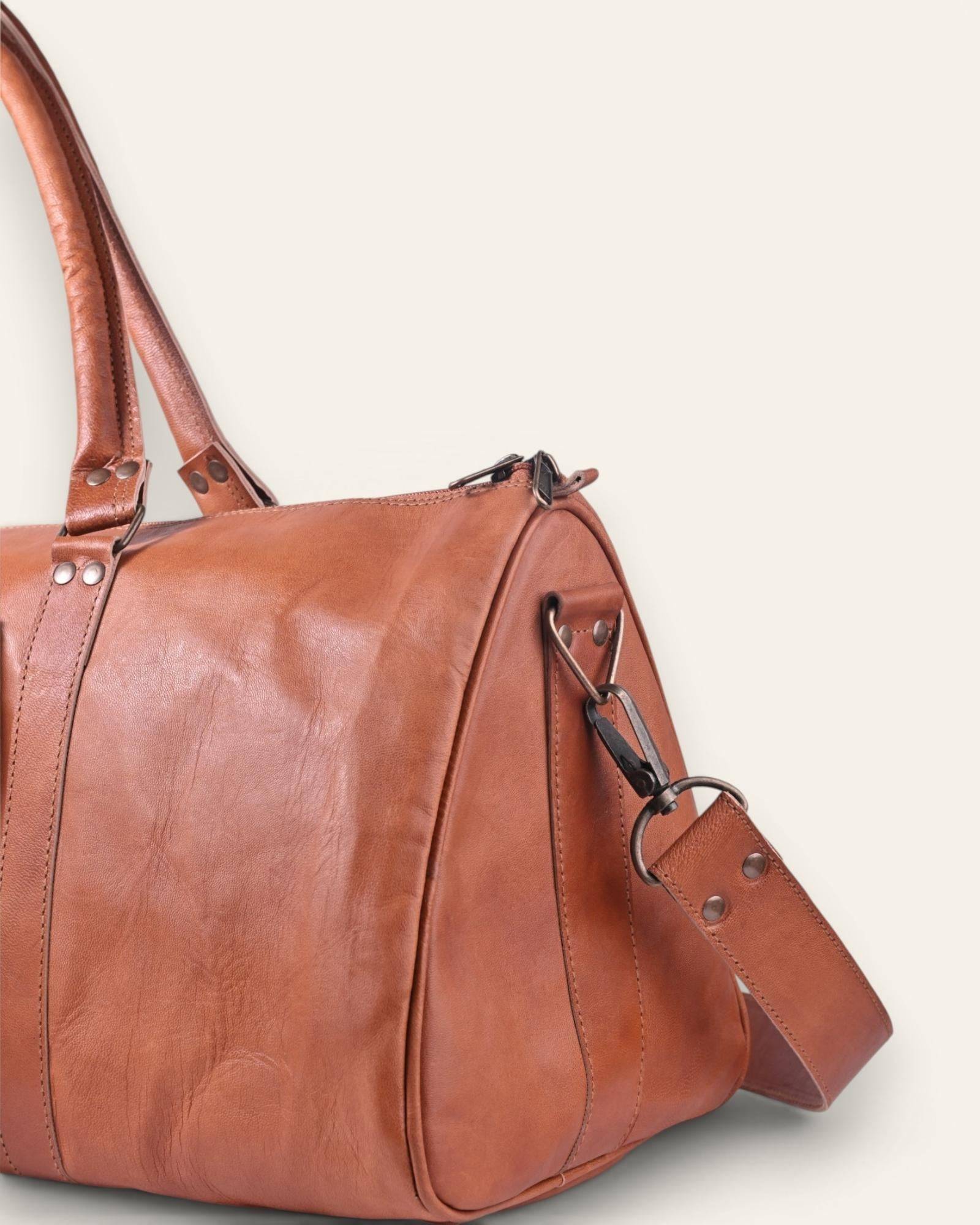 The Amer Weekender — distinctive triangle-profile tan leather duffel bag