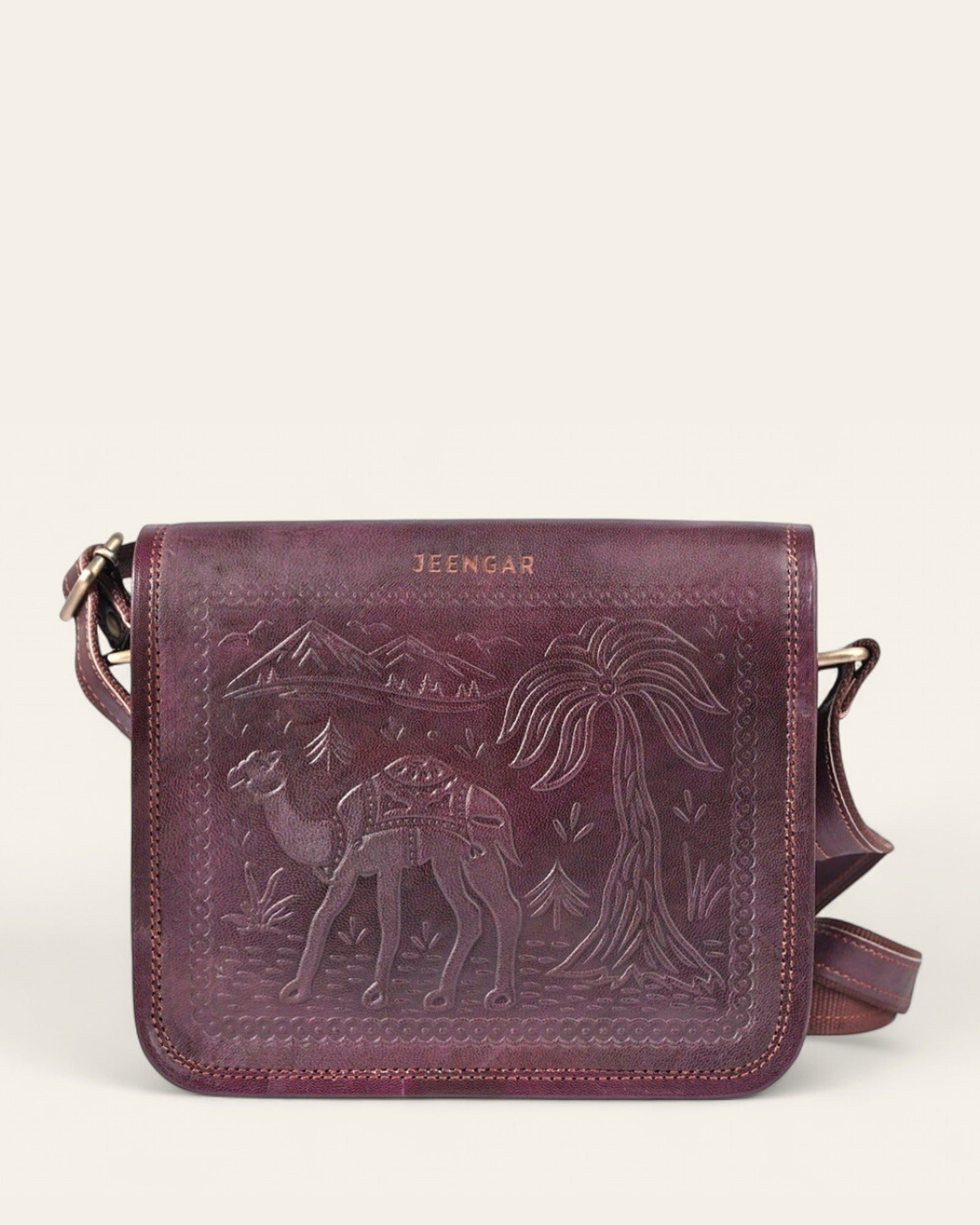 The Jaisalmer Sling in Cherry - hand-embossed camel and desert motif on Certified Real Leather, front view