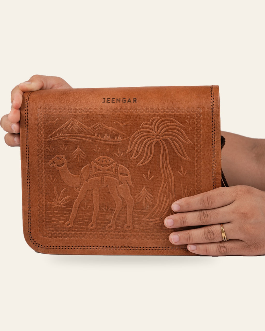 The Jaisalmer Sling in Tan held in hand — compact everyday scale