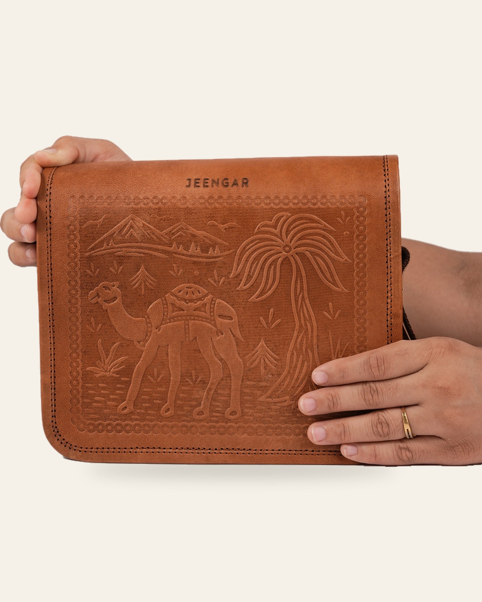 The Jaisalmer Sling in Tan held in hand — compact everyday scale