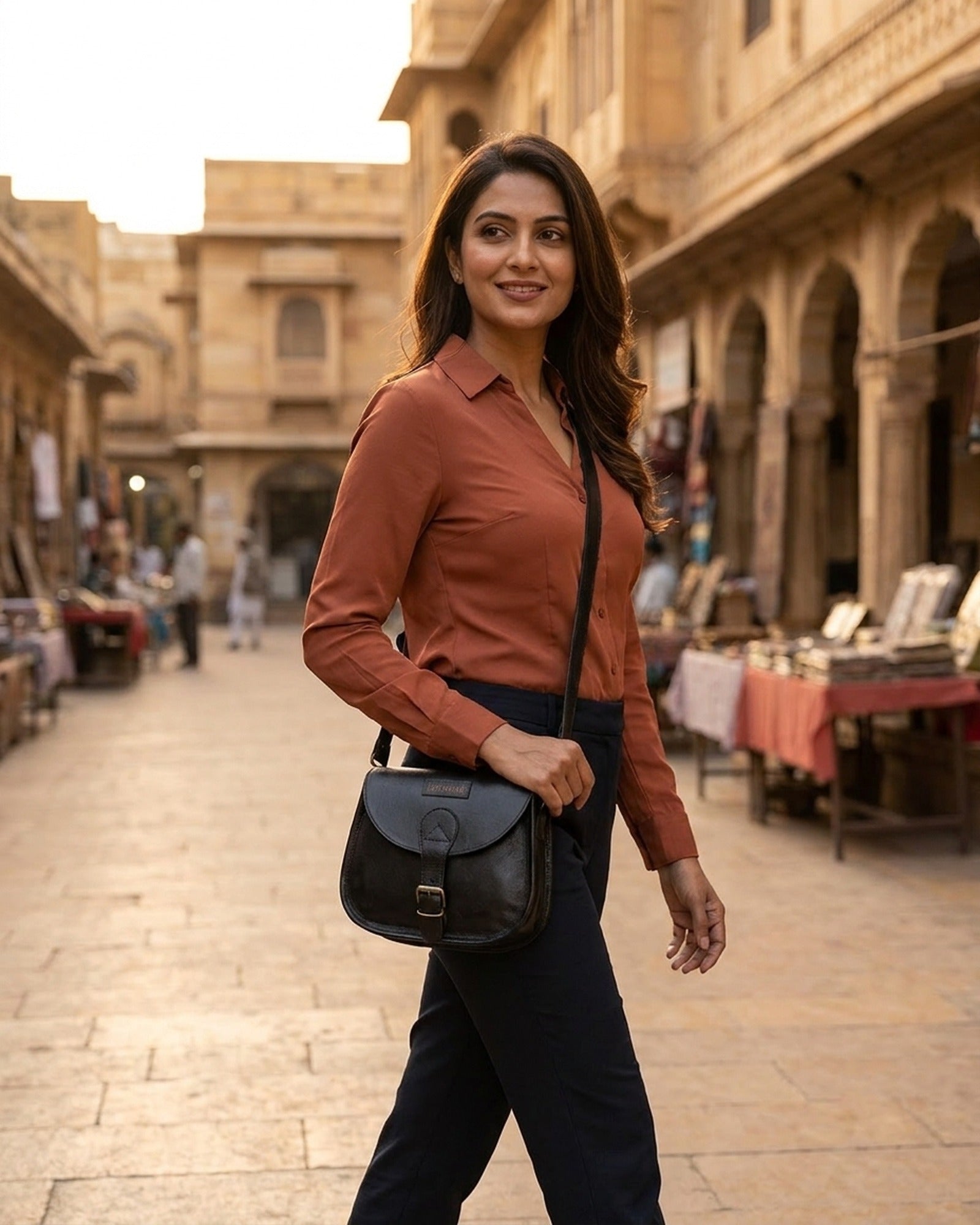 The Marwari Sling in Black worn cross-body at dusk