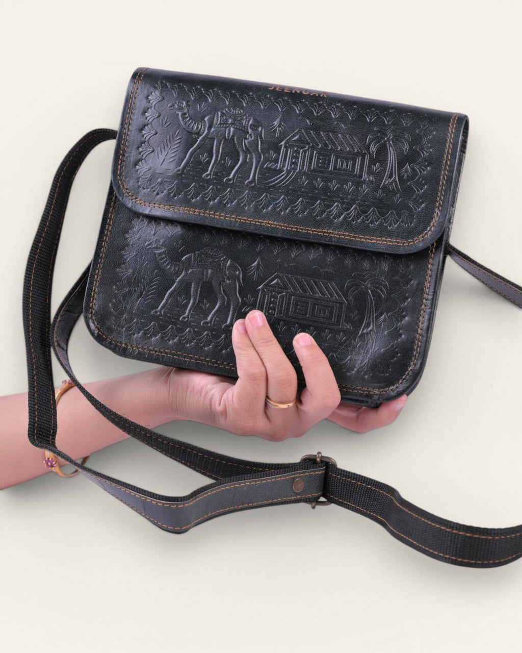 The Pushkar Sling in Dark Olive — embossed desert scene