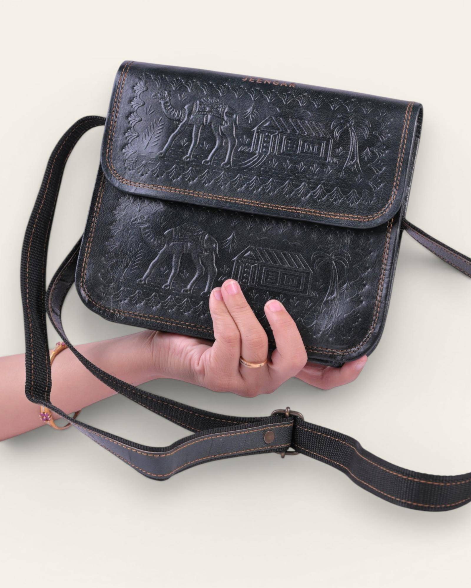 The Pushkar Sling in Dark Olive — embossed desert scene