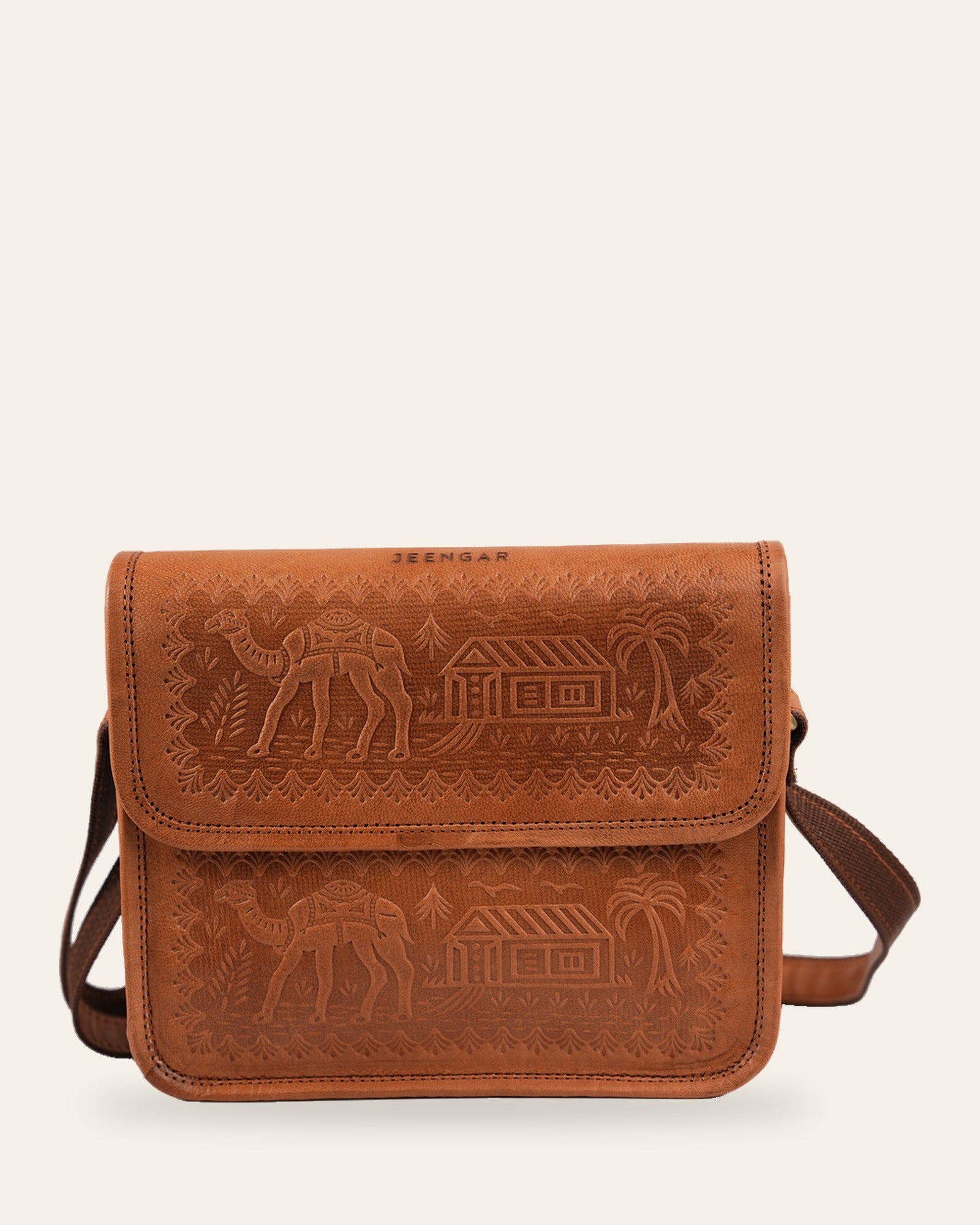The Pushkar Sling in Tan — hand-embossed camel and desert dwelling motif with JEENGAR stamp, front view