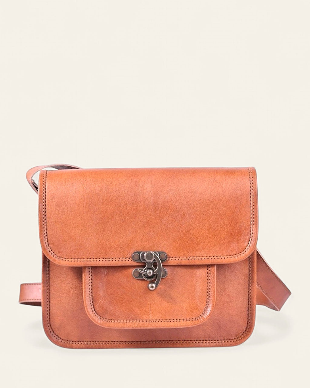 The Taragarh Satchel — handcrafted tan real leather satchel with antique-brass tuck clasp, front view