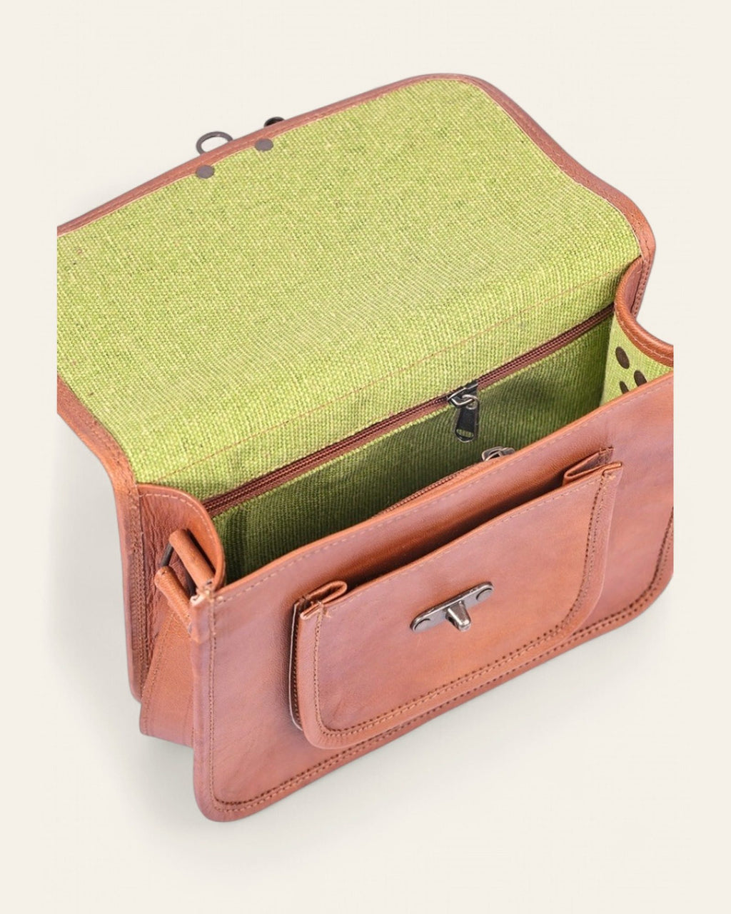 The Taragarh Satchel — open flap showing the bright green canvas interior and front pocket
