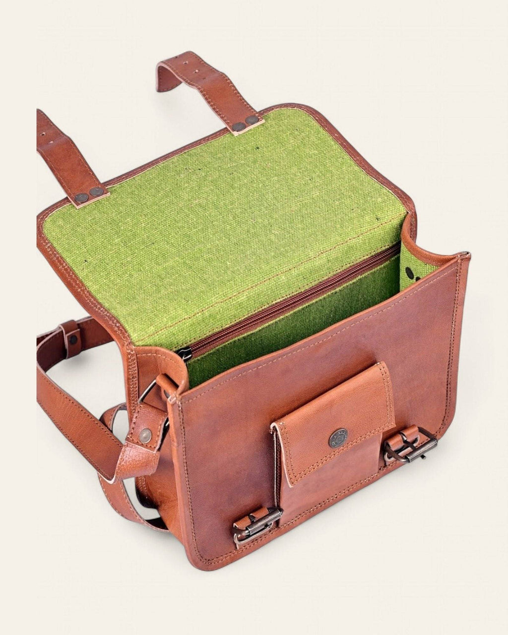 The Jaigarh Sling open, revealing its bright-green canvas interior and front pocket