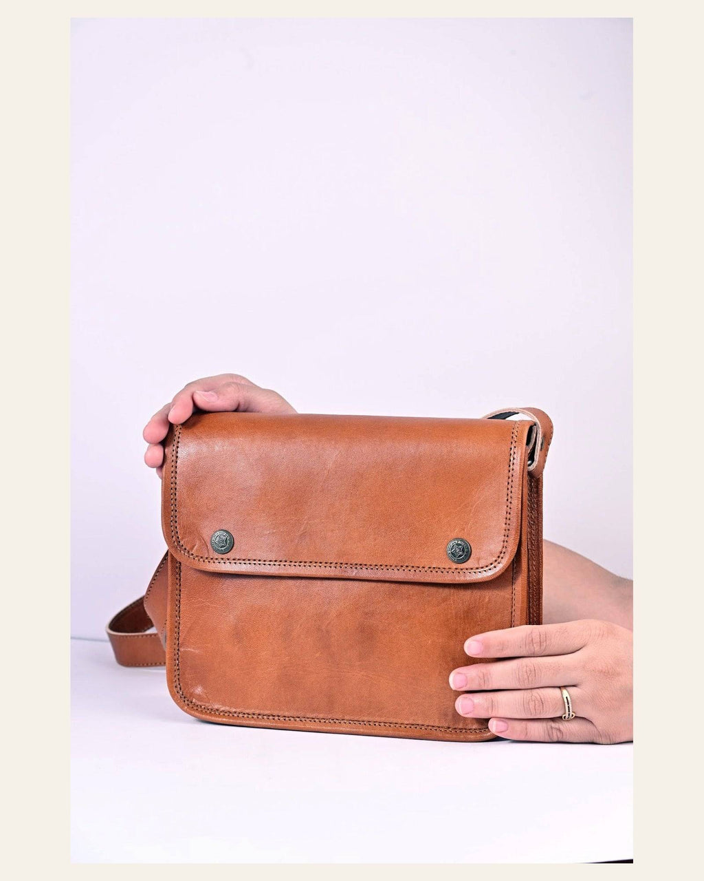The Sojat Sling held in hand to show its compact everyday scale