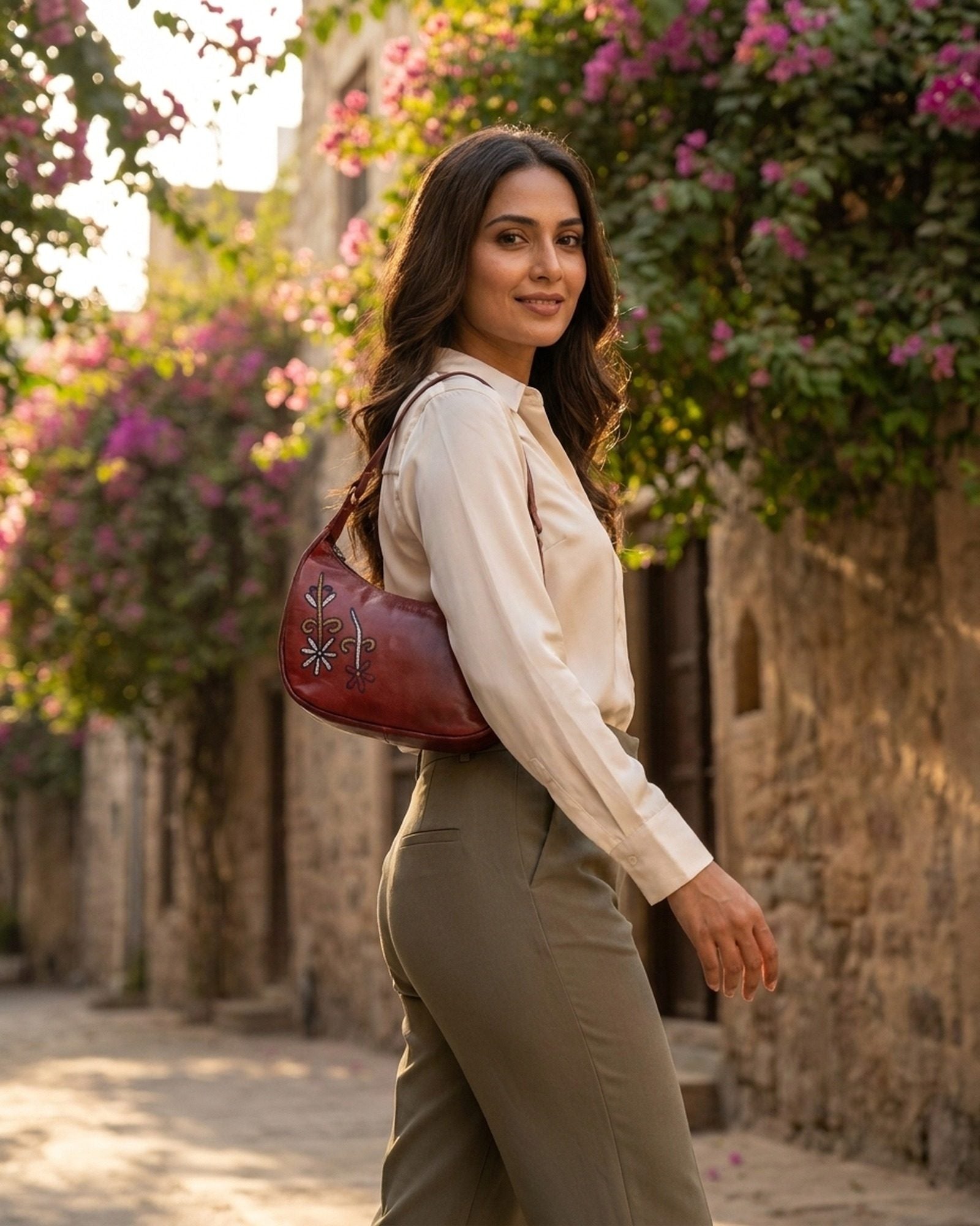 The Kashida Shoulder Bag Mira in Cherry worn on the shoulder