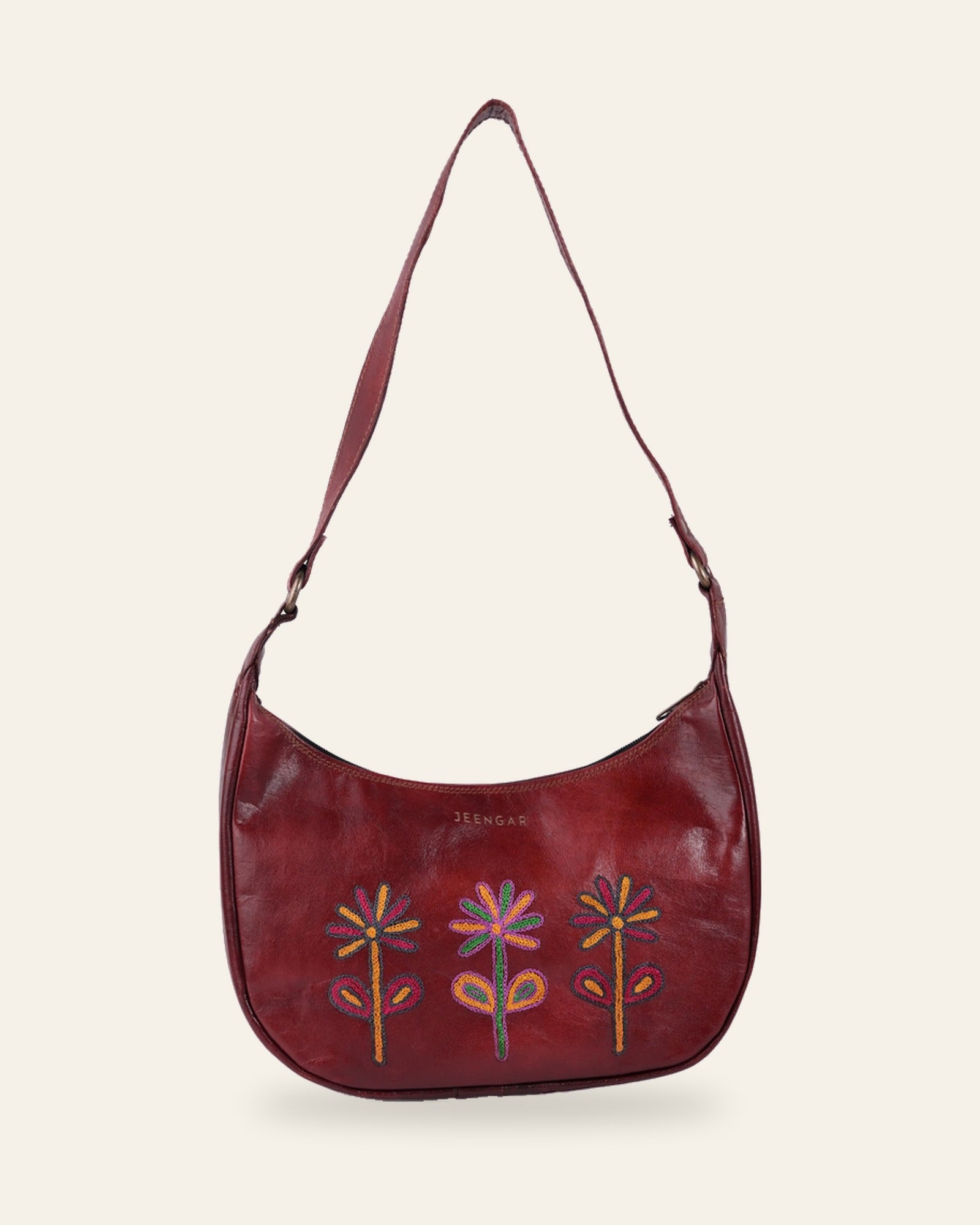 The Kashida Shoulder Bag — Sanyogita three-flower motif in Cherry, hand-embroidered real leather, front view