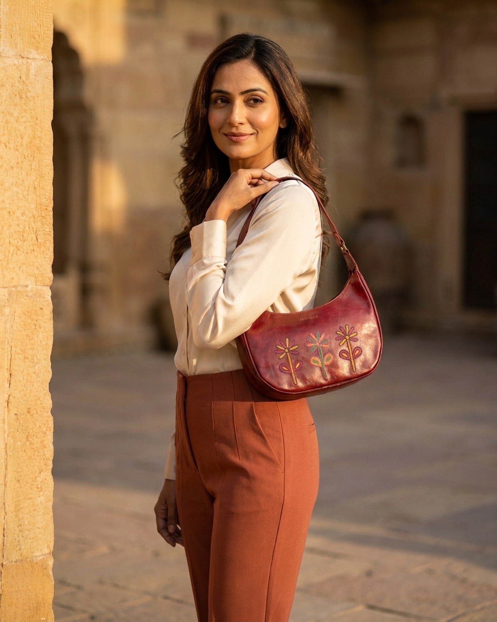 The Kashida Shoulder Bag Sanyogita in Cherry worn on the shoulder
