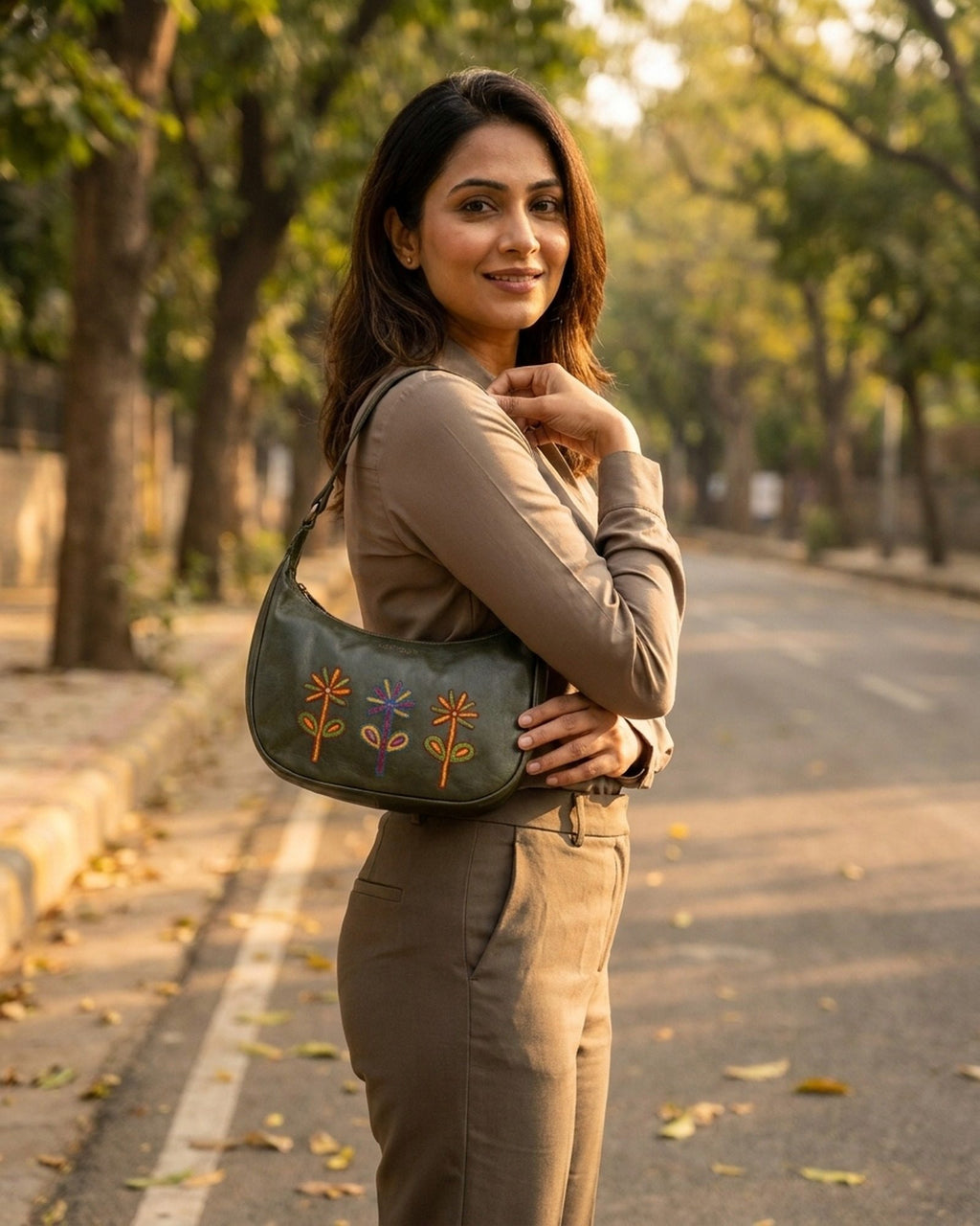 The Kashida Shoulder Bag Sanyogita in Dark Olive worn on the shoulder
