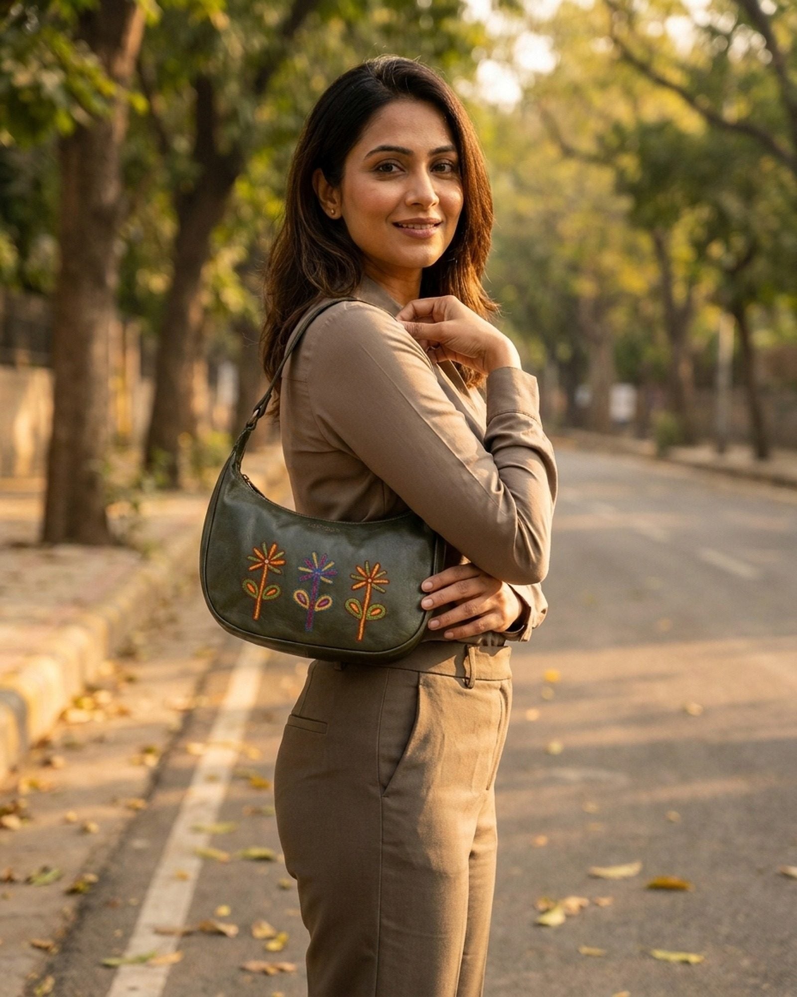 The Kashida Shoulder Bag Sanyogita in Dark Olive worn on the shoulder