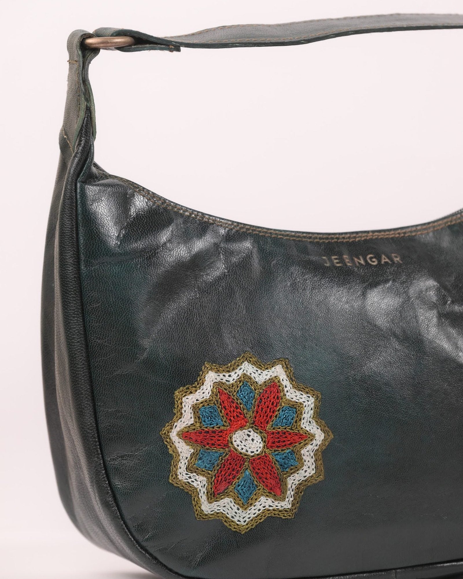 The Kashida Shoulder Bag — closeup of the hand-embroidered Hadi mandala medallion in Dark Olive