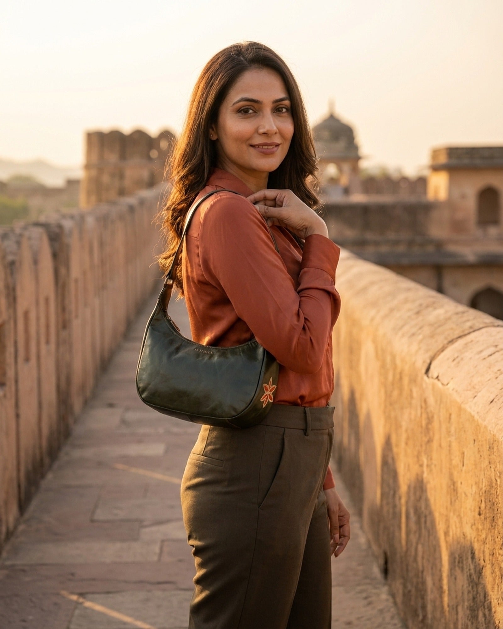 The Kashida Shoulder Bag Moomal in Dark Olive worn on the shoulder