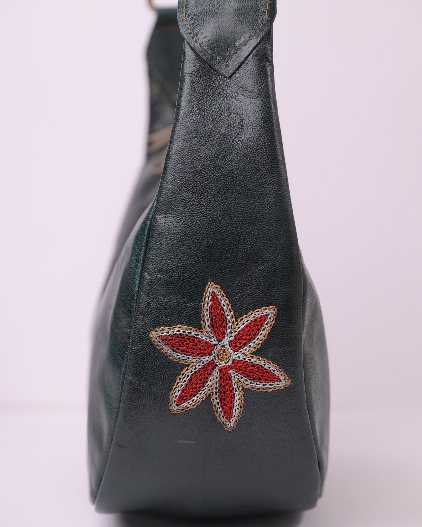 The Kashida Shoulder Bag — closeup of the hand-embroidered Moomal star flower in Dark Olive