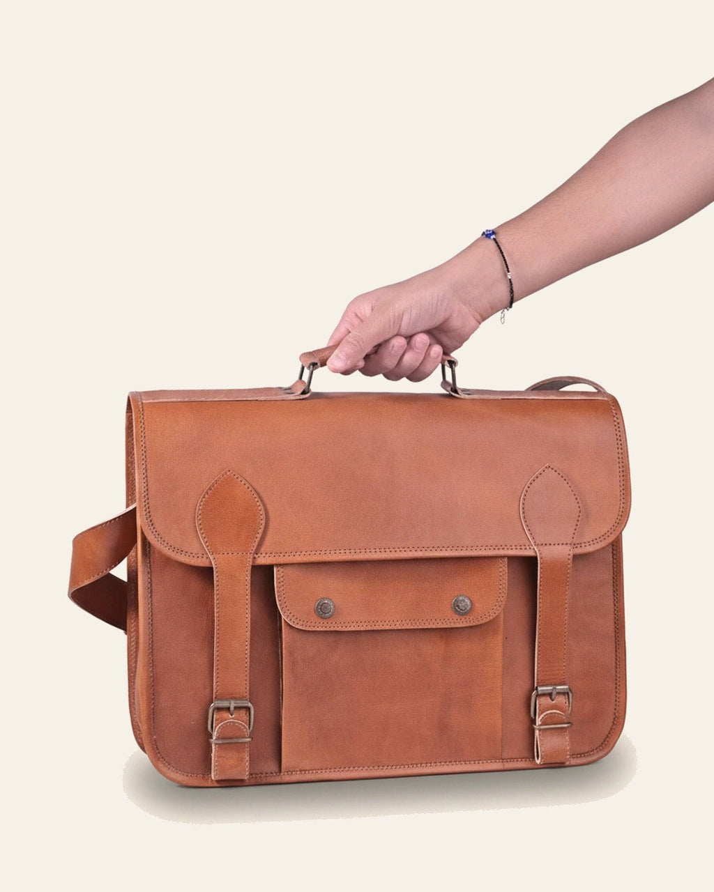 The Pali Laptop Bag held in hand to show its scale
