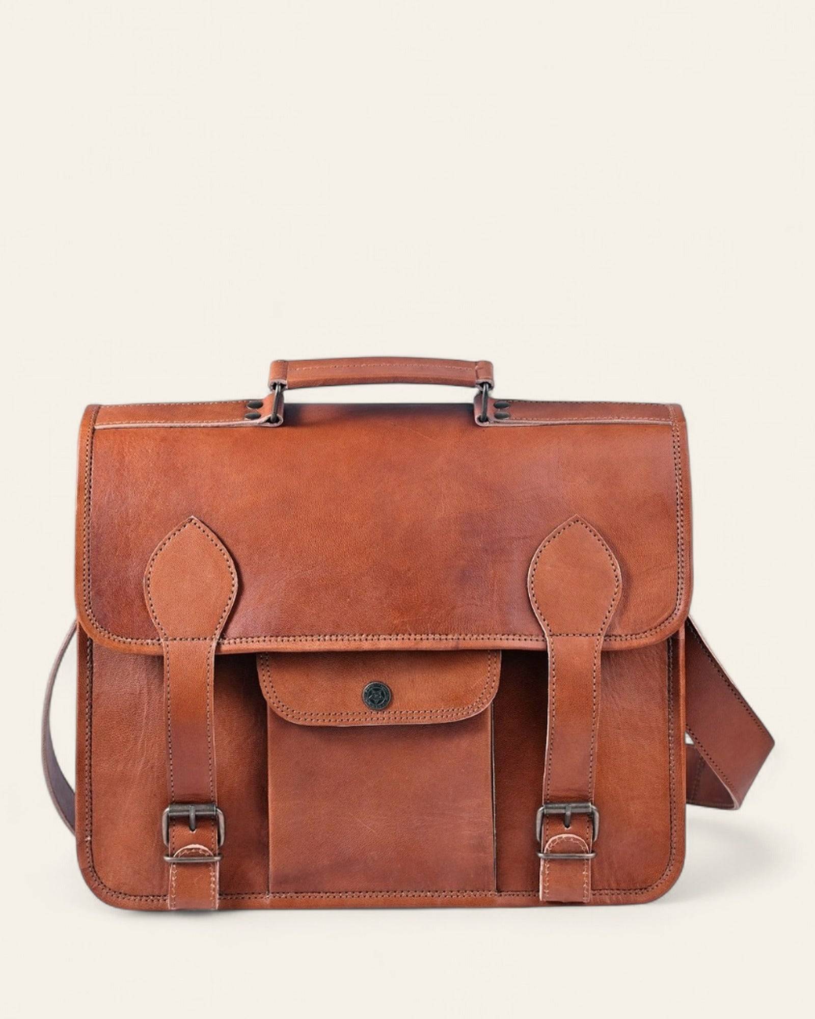The Jaipur Laptop Bag in natural certified leather, front view with twin buckle straps and top handle