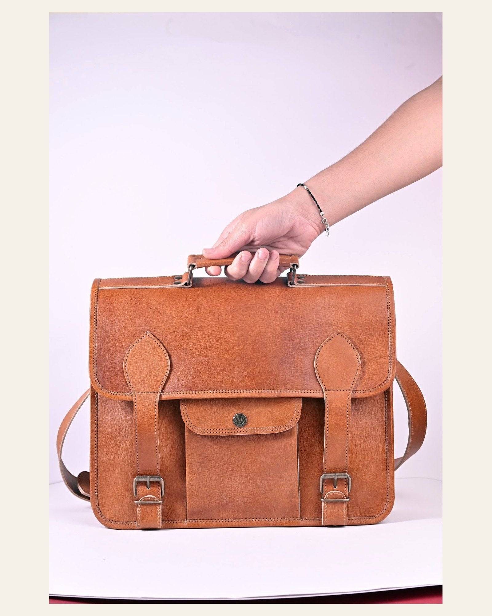 The Jaipur Laptop Bag carried by its top handle to show scale