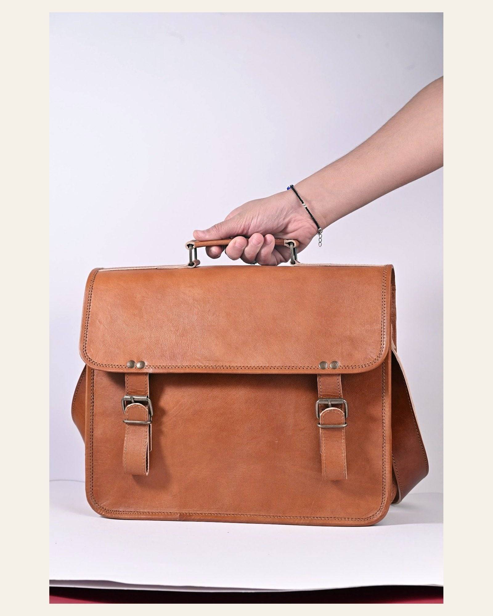 The Ajmer Laptop Bag carried by its top handle to show scale