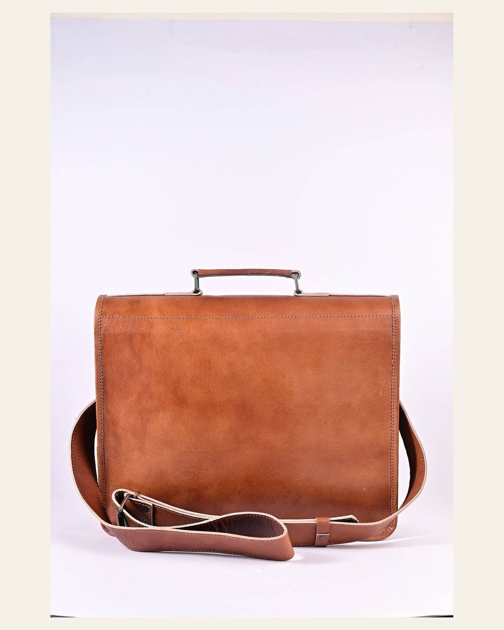 The Mangla Laptop Bag held in hand to show its scale