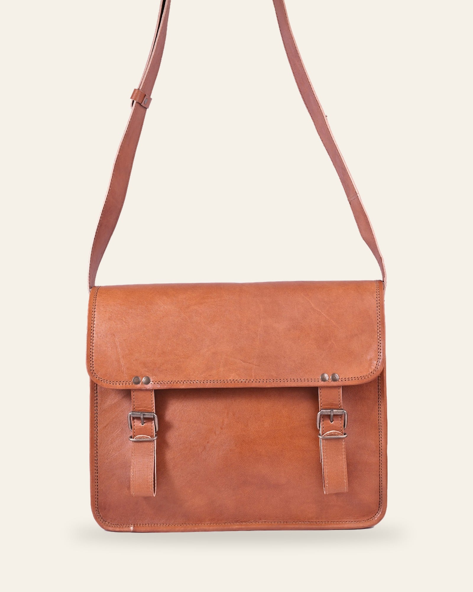 The Umaid Briefcase 15-16 in — handcrafted tan real leather laptop briefcase with twin buckle straps, front view