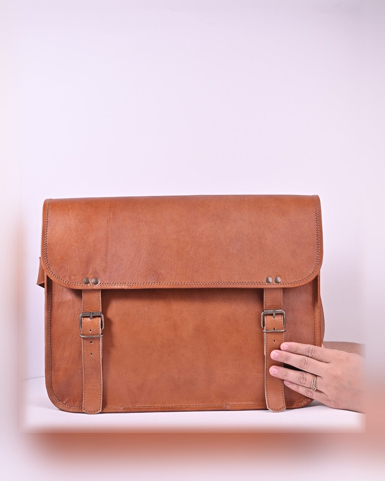 The Umaid Briefcase 13-14 in held in hand — slim executive scale