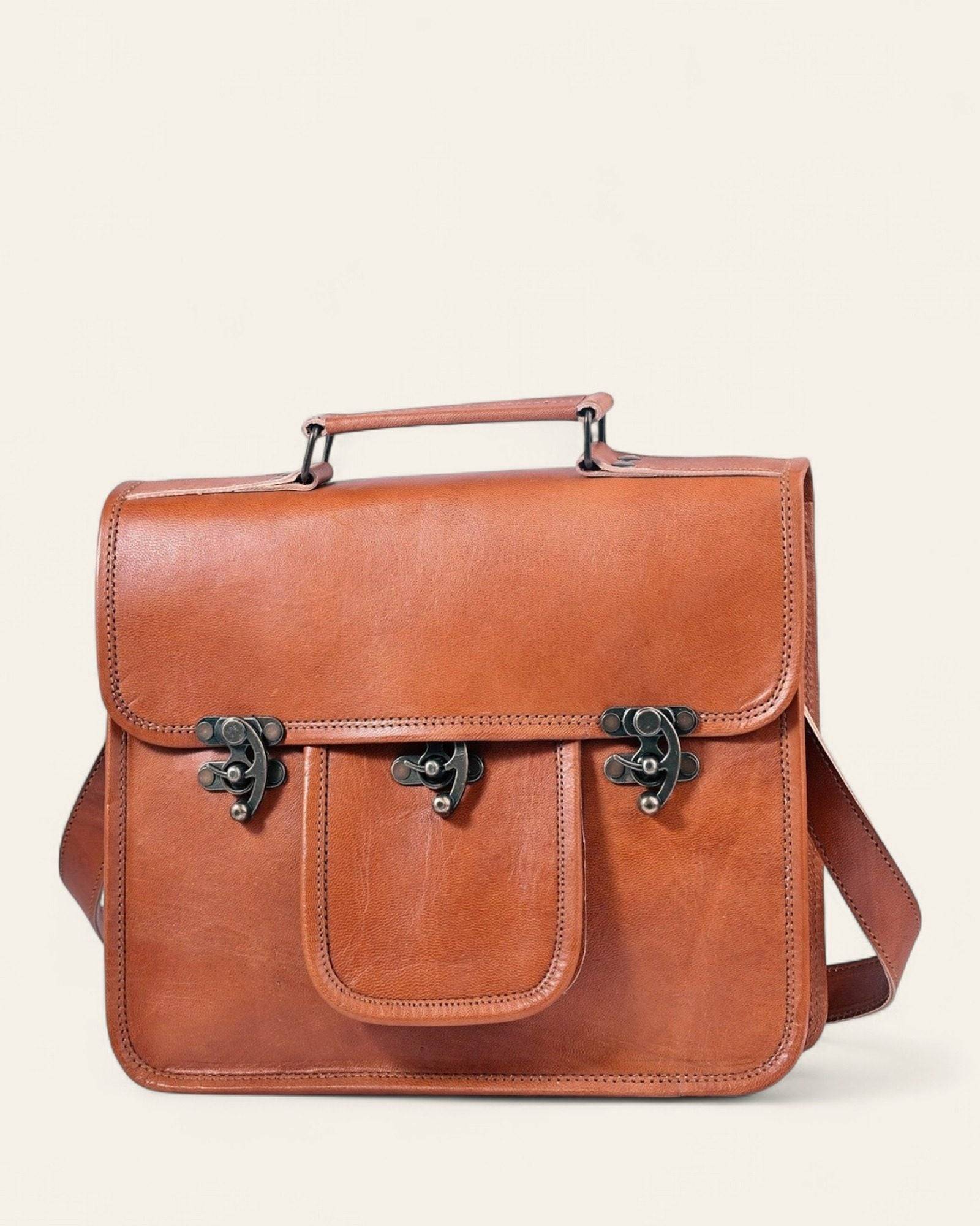 The Malani Messenger in natural-brown certified real leather — front view with twist-lock pocket and top handle