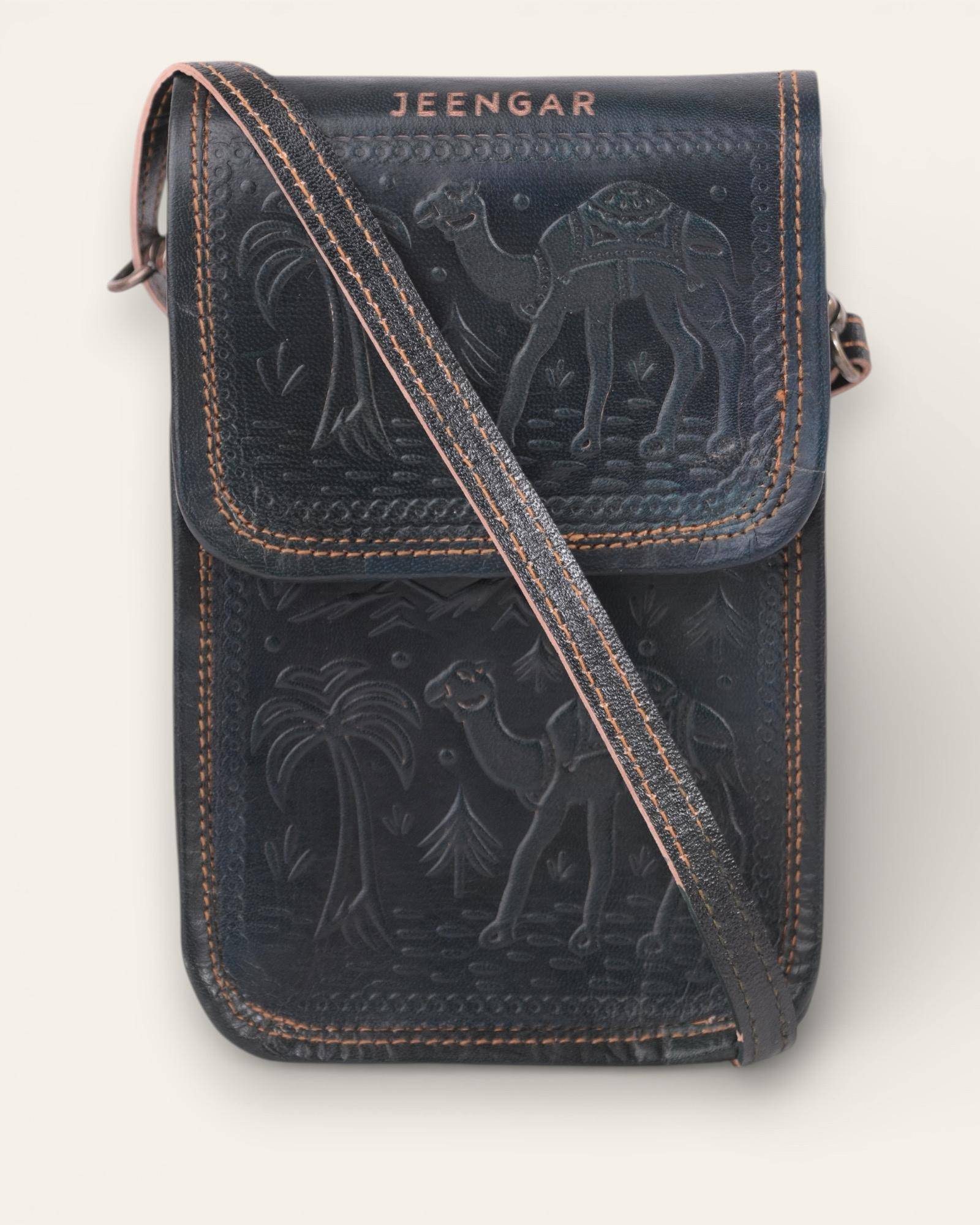 The Nagaur Sling in Dark Olive — hand-embossed leather mobile sling, front view