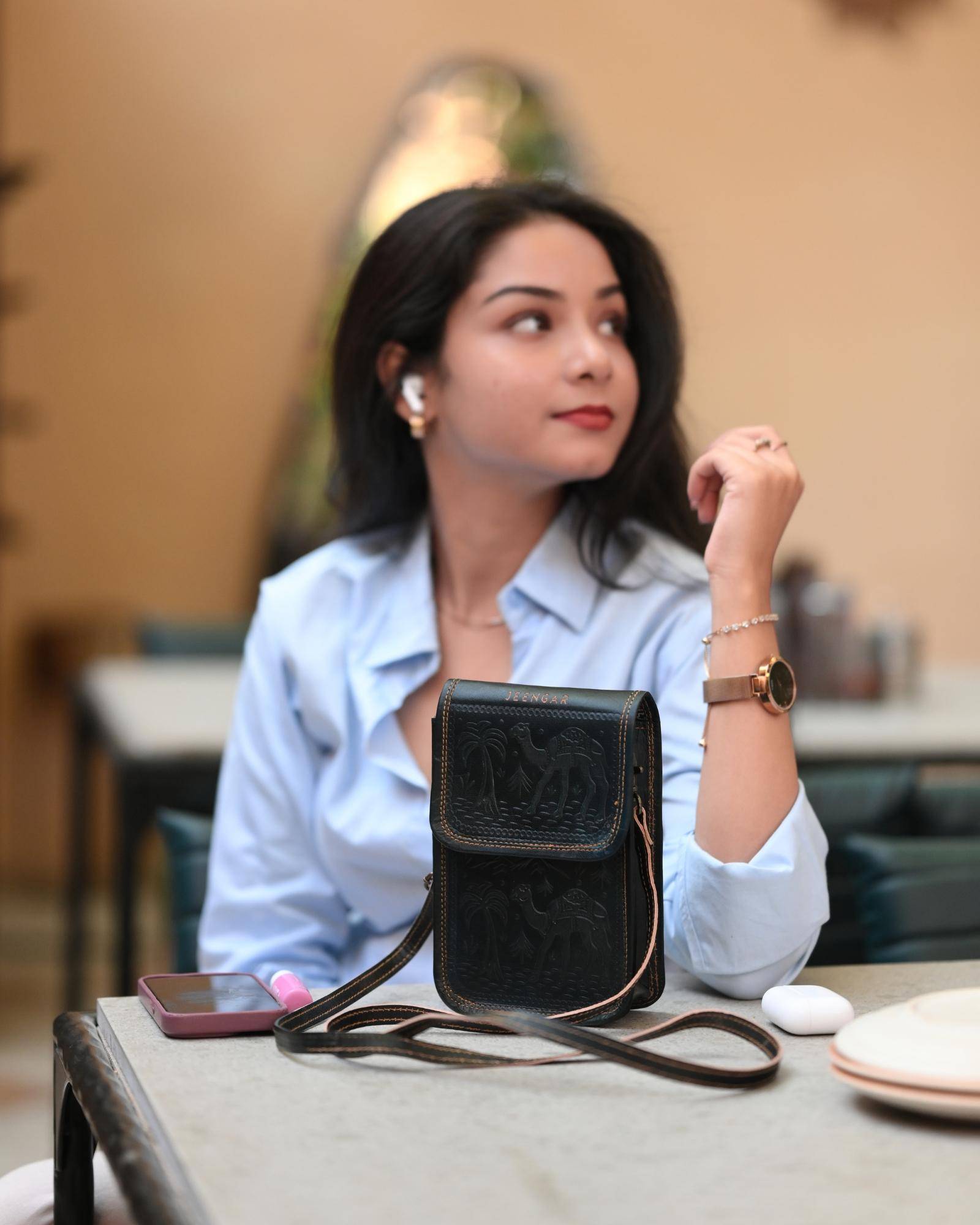 The Nagaur Sling in Dark Olive — embossed desert caravan motif on real leather
