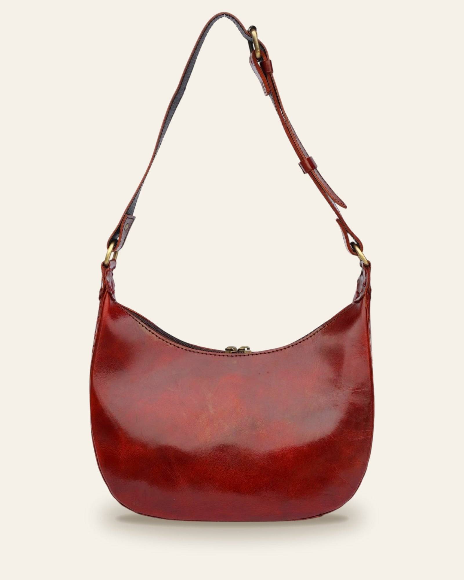The Ranisar Shoulder Bag in Cherry — front view with JEENGAR patch and antique brass hardware