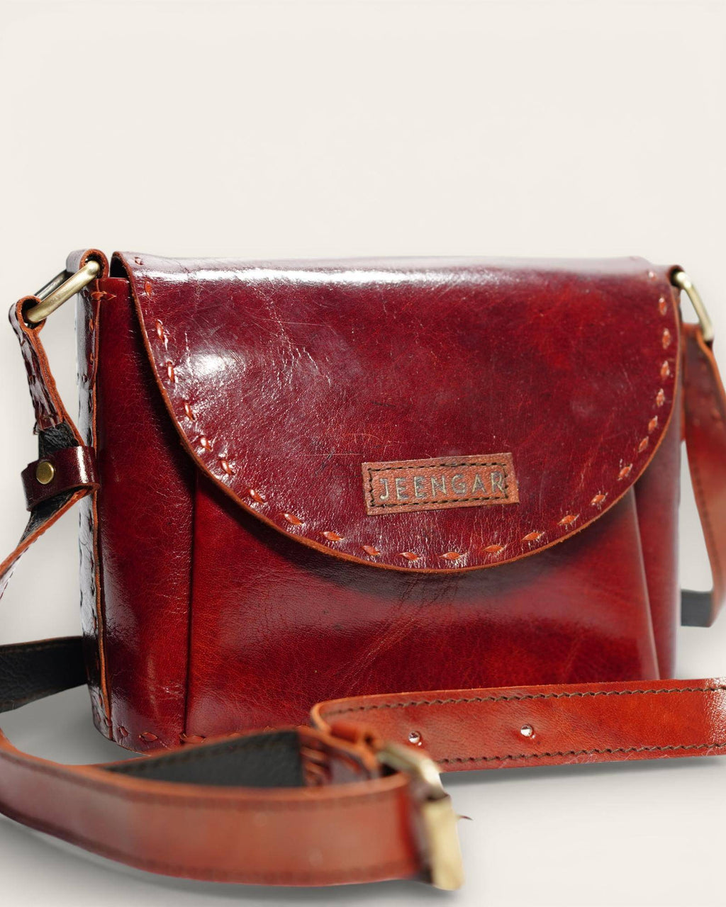 The Beawar Sling in Cherry — hand-stitched leather crossbody, front view