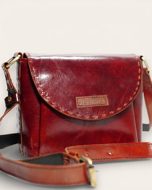 The Beawar Sling in Cherry — hand-stitched leather crossbody, front view