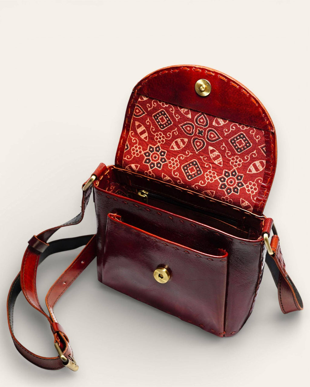 The Beawar Sling in Cherry — glossy leather sling bag by Jeengar
