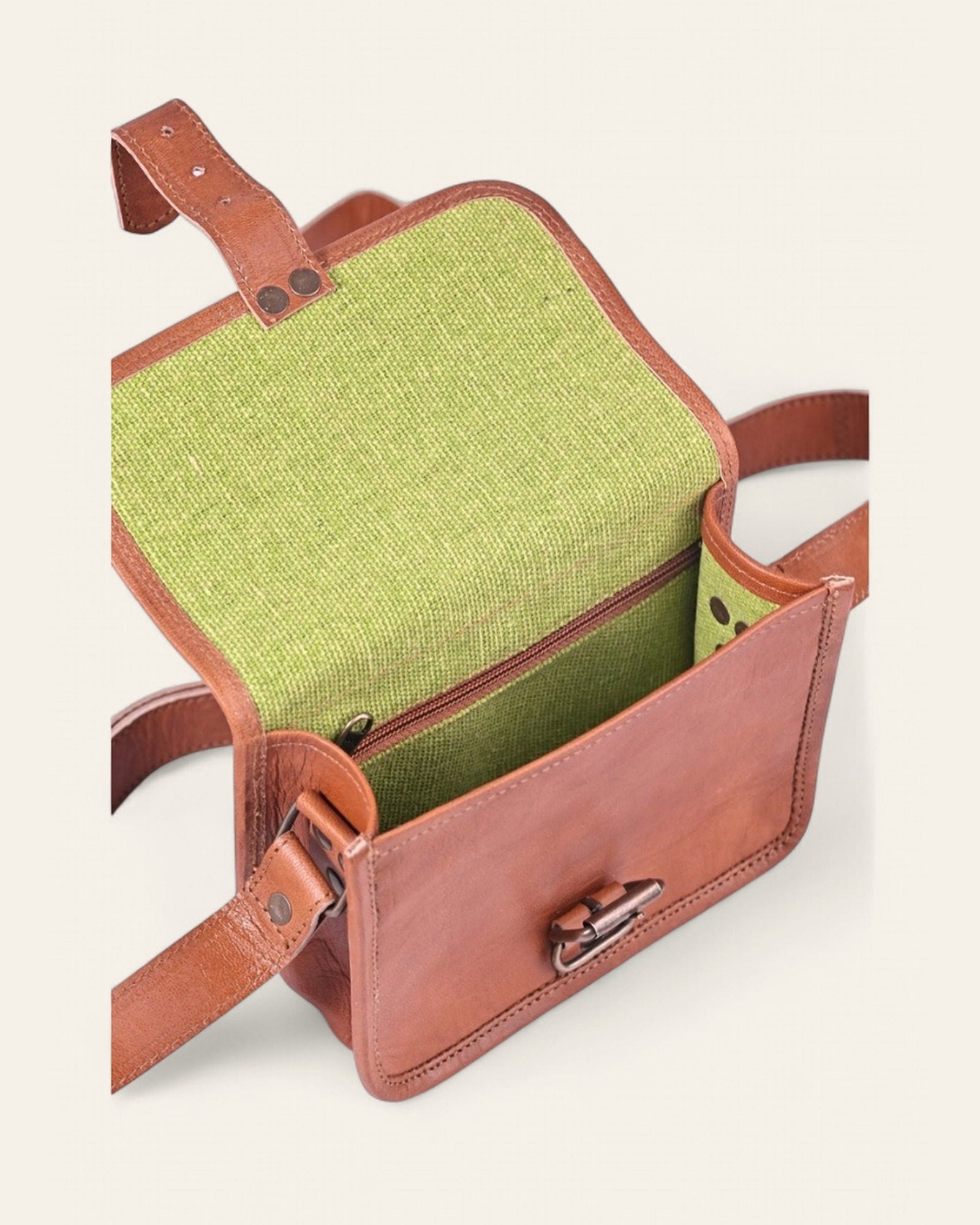 The Alwar Mini Satchel — open flap showing the bright green canvas interior