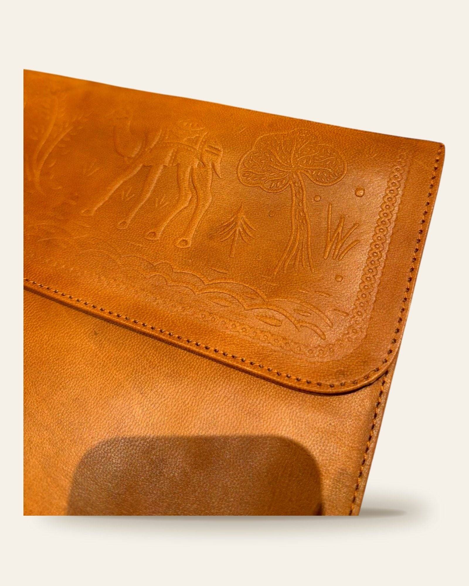 The Barmer Tech Sleeve — close-up of the embossed camel caravan motif