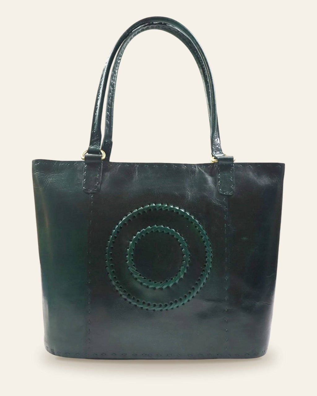 The Rambagh Tote — front view with woven medallion in Certified Real Leather