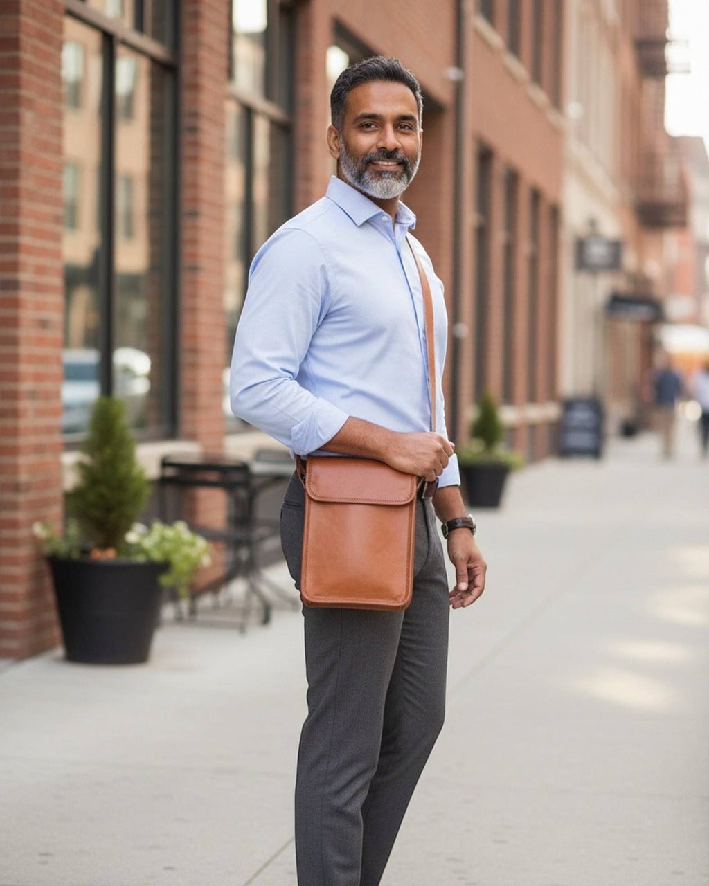 Man wearing The Phalodi Sling crossbody on a city street