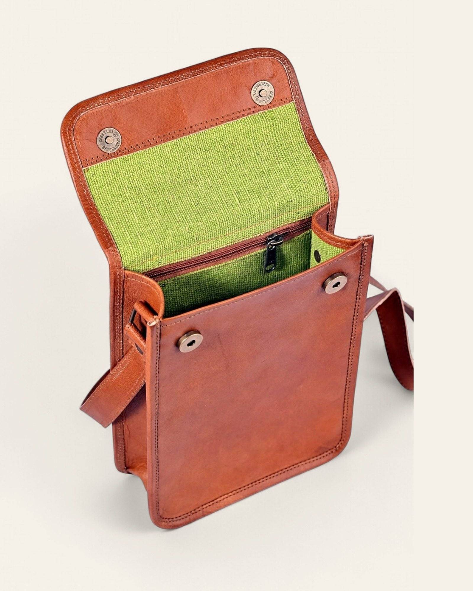 The Phalodi Sling open, revealing its bright-green canvas interior
